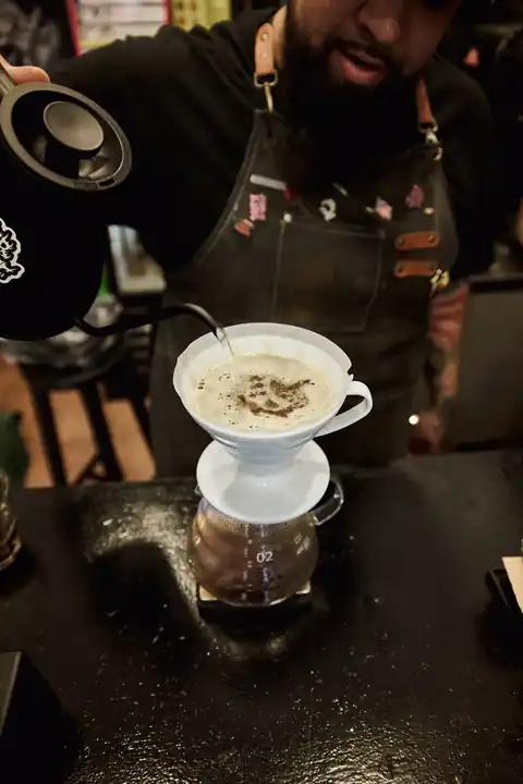Manny preparing a pour-over coffee at SuperHet Coffee